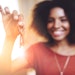 beautiful black woman holding key backlit blurred focus