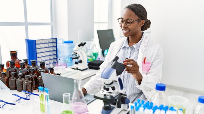Beautiful Young Chemist In Lab Hair Tied Back Smiling Working Adobe Stock 563756243