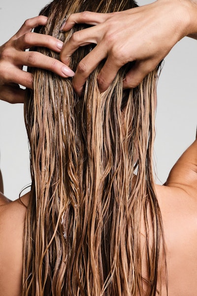 Model using Paul Mitchell Clear products in her hair.