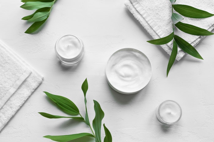 White Skin Care Products On White Background With Green Leaves Adobe Stock 367281369