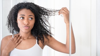 Woman With Black Curly Hair Looking At Split Ends Adobe Stock 1359958663
