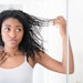 Woman With Black Curly Hair Looking At Split Ends Adobe Stock 1359958663