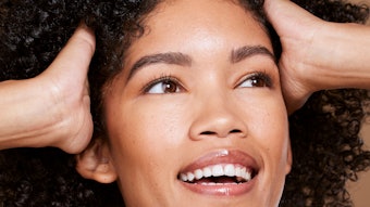 Woman With Curly Kinky Hair Smiling Hands In Hair Adobe Stock 546803711