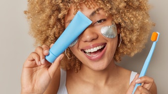 Beautiful Curly Haired Woman Under Eye Patches Oral Care And Tube Adobe Stock 503376344