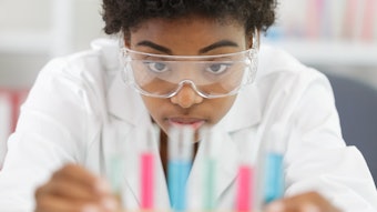 Chemist At Bench Examining Samples Adobe Stock 318722948