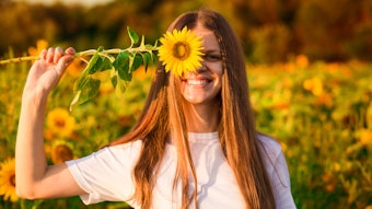 Woman In Sunflower Field Flower Over One Eye Arm Up Smiling Adobe Stock 263886931