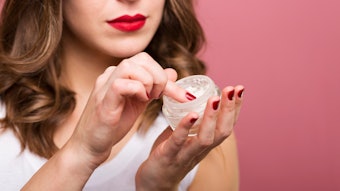 Woman With Red Nails And Lipstick Using Facial Cream Adobe Stock 94437118