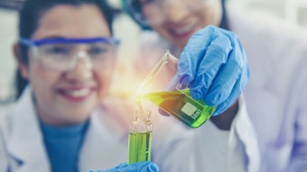 Female Chemists In Lab Holding Beaker Lit Up Adobe Stock 318999036
