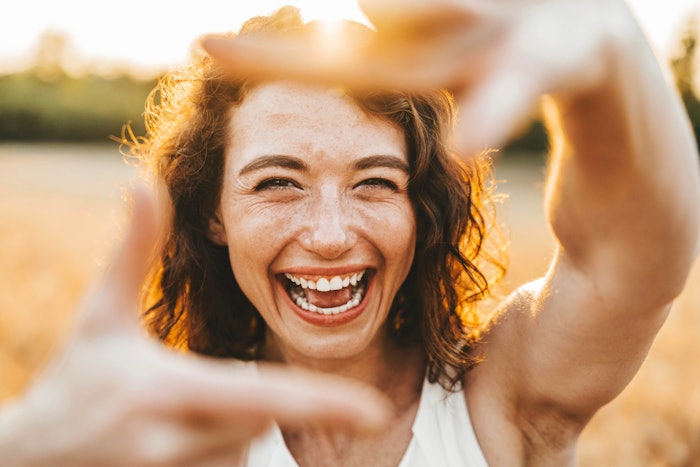 Happy Woman Smiling Laughing Framing Face With Fingers Outside Sunlight Backlit Adobe Stock 758768316