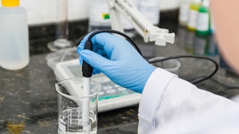 Lab Technician Measuring P H In Beaker Adobe Stock 296421026