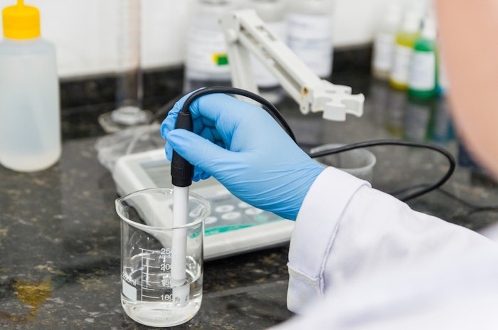 Lab Technician Measuring P H In Beaker Adobe Stock 296421026