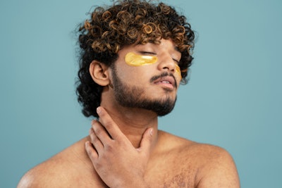 Man Using Under Eye Patches Relaxed Antiaging And Wellness Theme Adobe Stock 618306423