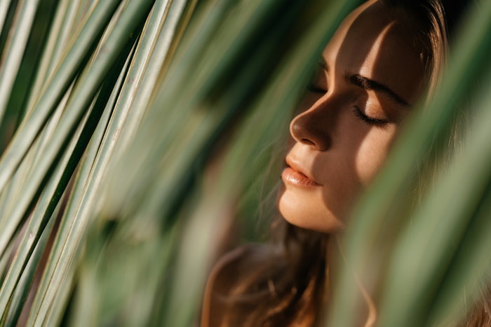 Natural Woman Beauty In Leaves Sun Shining Through Eyes Closed Adobe Stock 397528386