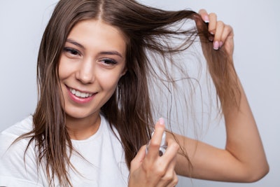 Woman Brunette Using Hair Detangler Treatment Spray Happy Smiling Adobe Stock 417234881