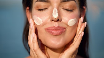 Woman Outside Sunscreen Dabbed On Face Adobe Stock 1325038807