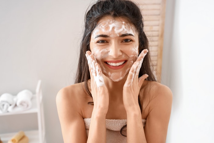 Young Brunette Washing Her Face In Bathroom Foam Smiling Adobe Stock 477816064