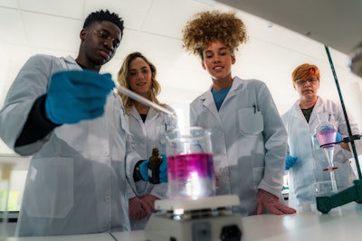 Young Scientists In Lab Group Working Together Formula Adobe Stock 1344523734