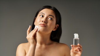 Beautiful Asian Woman Cleansing Face Some Acne Adobe Stock 718183258
