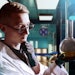Chemist In Lab Looking At Liquid In Flask Thinking Adobe Stock 853750305
