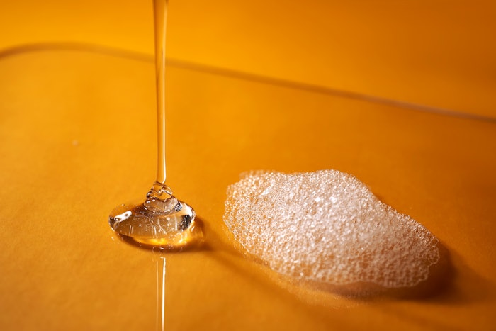 Clear Liquid And Foam On Orange Background I Stock 1448099587 Med (1)