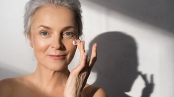 Mature Woman With Beautiful Skin Using Face Cream Adobe Stock 439330899