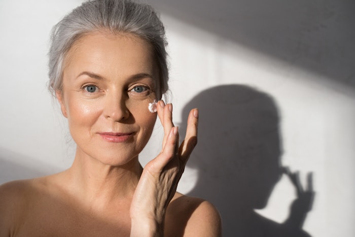 Mature Woman With Beautiful Skin Using Face Cream Adobe Stock 439330899