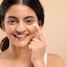 Young Indian Woman Using Eye Cream Smiling Adobe Stock 750183058 (1)