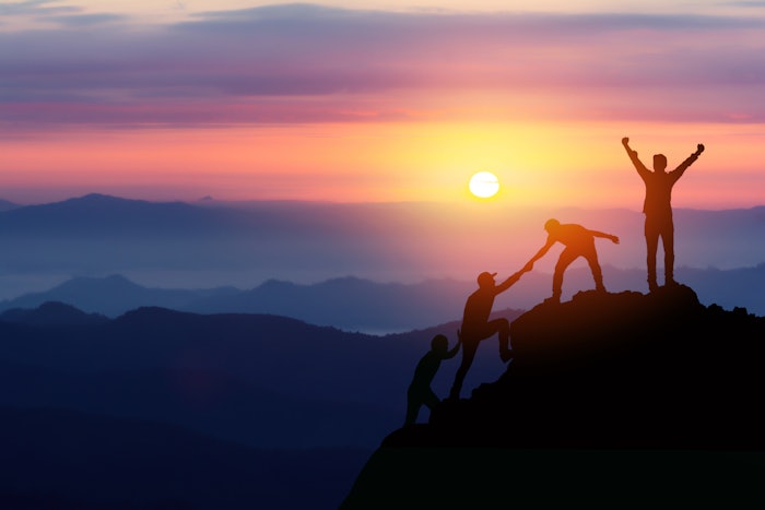 People Climbing Mountain Together Bright Purple And Orange Sunset Adobe Stock 363563655