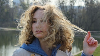 Woman Outside Near Waterin Overcoat Frizzy Hair Pulling Strand Adobe Stock 353924925