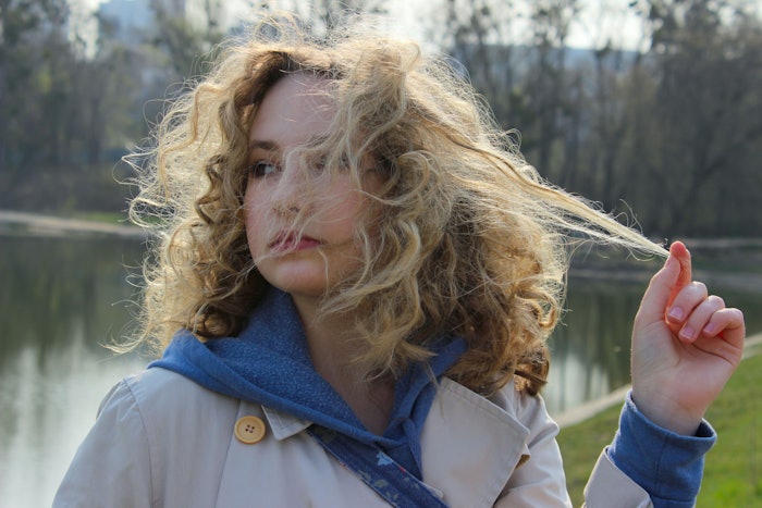 Woman Outside Near Waterin Overcoat Frizzy Hair Pulling Strand Adobe Stock 353924925