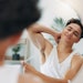 Man With Deodorant In Mirror Adobe Stock 1363485883