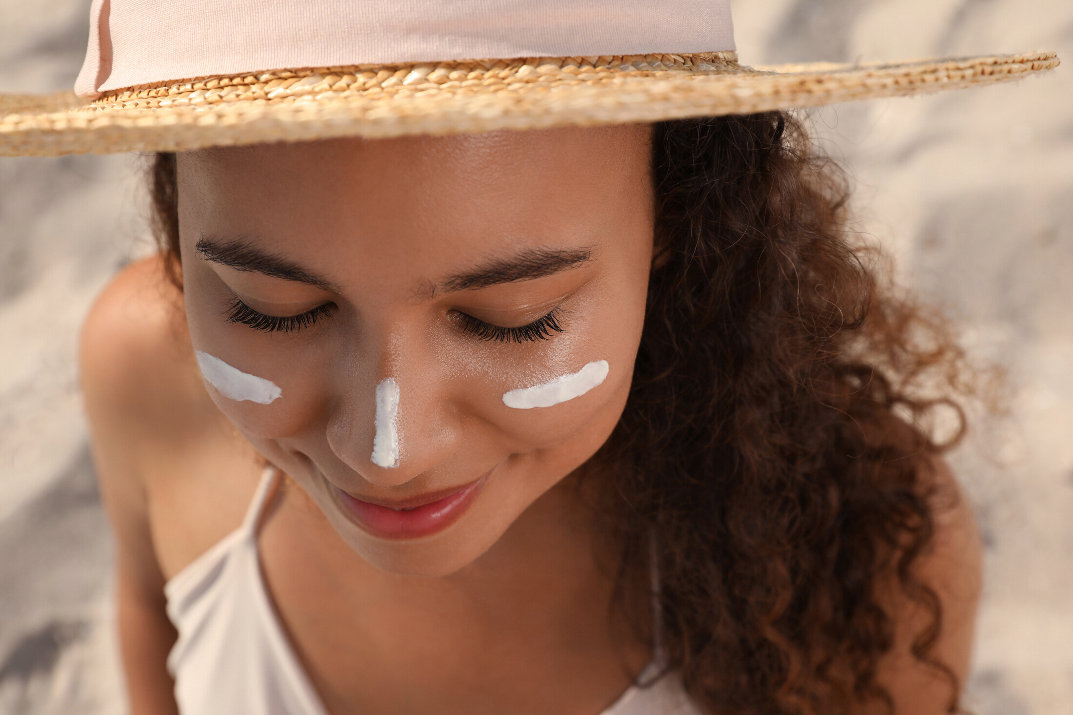 Woman In A Hat At Beach Sunscreen On Face Adobe Stock 458234417