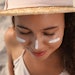 Woman In A Hat At Beach Sunscreen On Face Adobe Stock 458234417