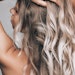 Woman With Beautiful Long Blonde Hair Wavy Held Above Her Head Adobe Stock 480419142