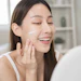 Beautiful Asian Woman Using Skin Care Products