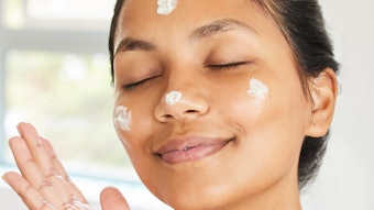 Beautiful Woman Applying Facial Moisturizer Adobe Stock 497985245
