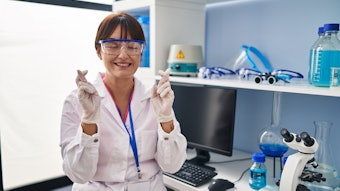 Chemist In Lab Fingers Crossed Eyes Closed Smiling Adobe Stock 542206955