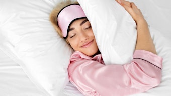 Woman In Bed In Pink Pjs Smiling Hugging Pillow Adobe Stock 1868783538 (1)