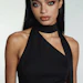 Woman in black halter top with sleek hair and dramatic makeup