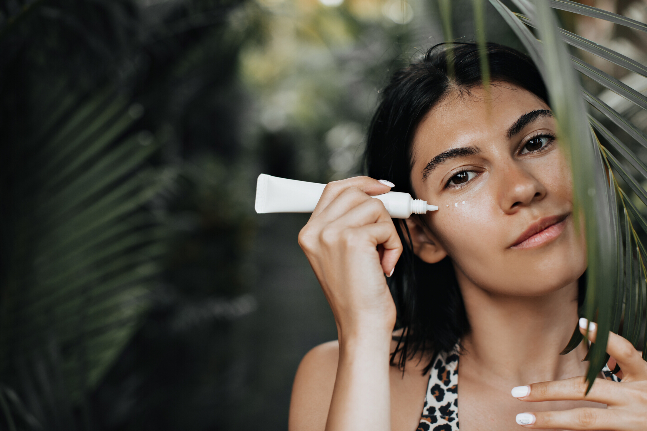 Woman In Jungle Greenery Sunscreen Tube Product On Face Adobe Stock 409772694