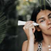 Woman In Jungle Greenery Sunscreen Tube Product On Face Adobe Stock 409772694