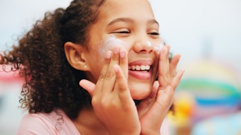 Young Girl Sunscreen Smiling Face Adobe Stock 1363935705