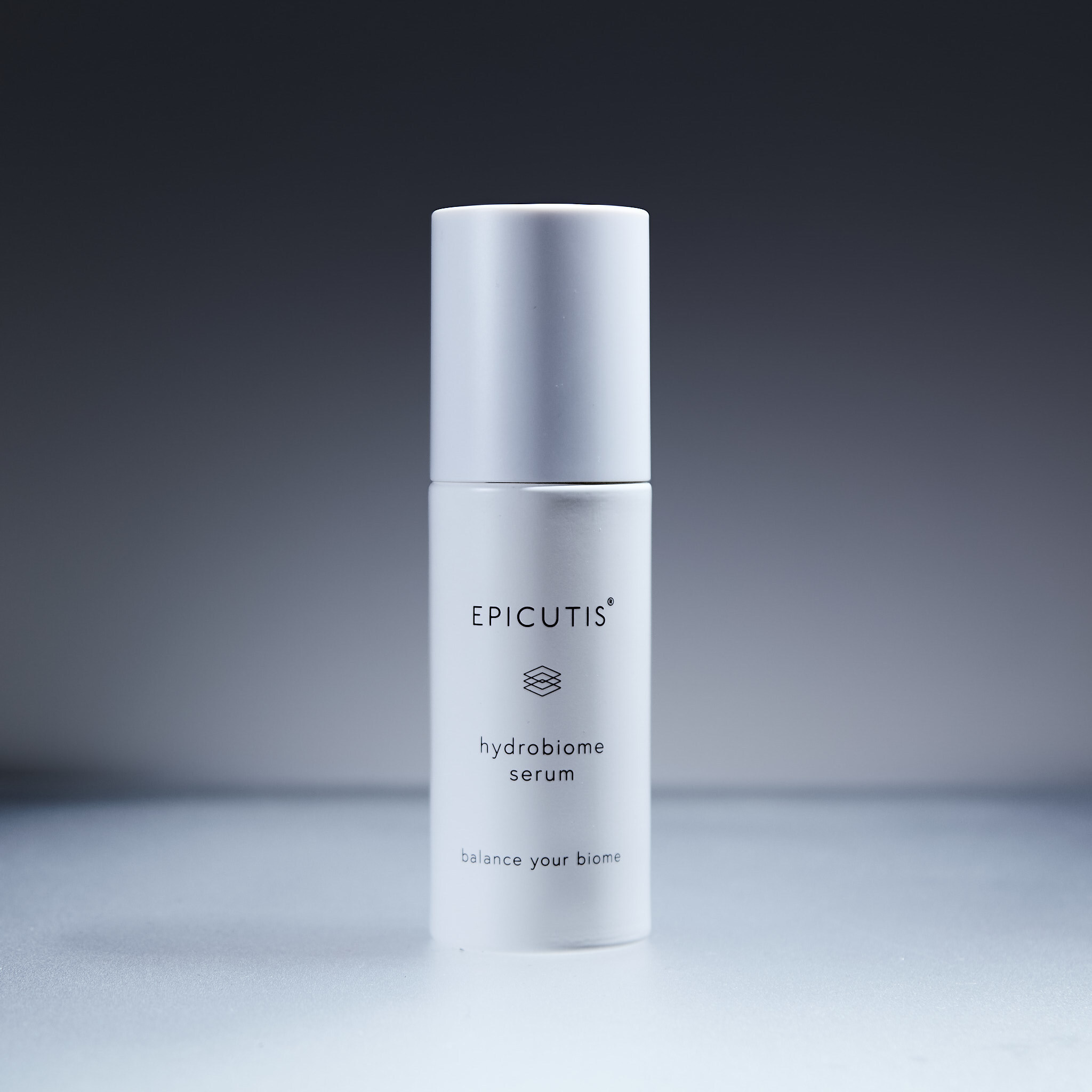 Epicutis Hydrobiome Serum white airless pump bottle with minimalist design on gray background