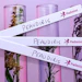 Padmini branded ribbons with botanical specimens in glass containers on purple background