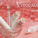 Beauty and skincare products displayed in a crystal bowl with pink cosmetic bottles and a cupcake-topped item against a gradient pink background
