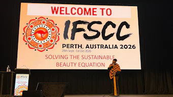 IFSCC Perth 2026 conference welcome slide with ornate red logo and speaker on stage
