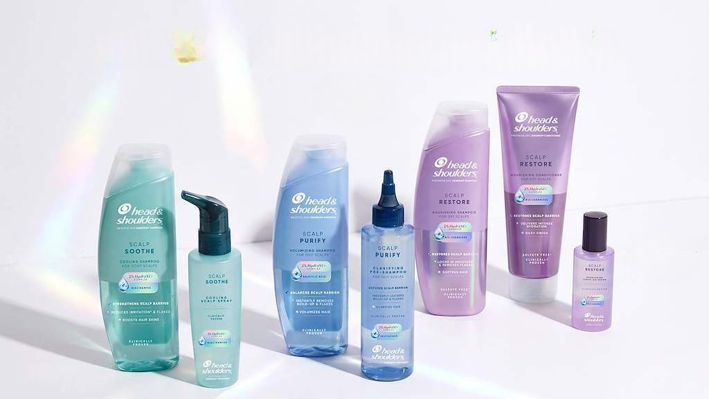 Head & Shoulders hair care product lineup featuring soothe, purity, and restore formulas in turquoise, blue, and purple bottles