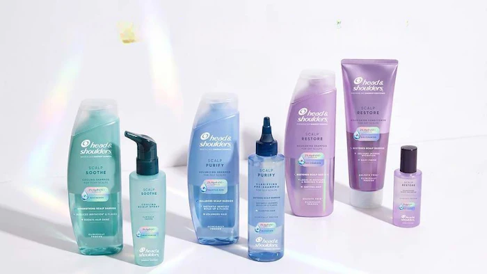 Head & Shoulders hair care product lineup featuring soothe, purity, and restore formulas in turquoise, blue, and purple bottles
